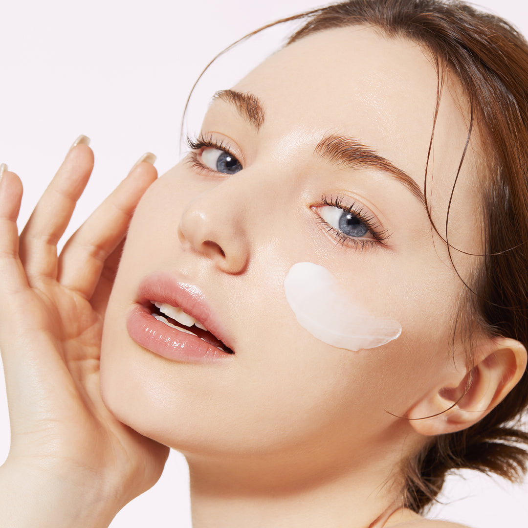 AgelessBeauty3000.com medicube | Triple Collagen Cream Woman applying cream to her face with a white background