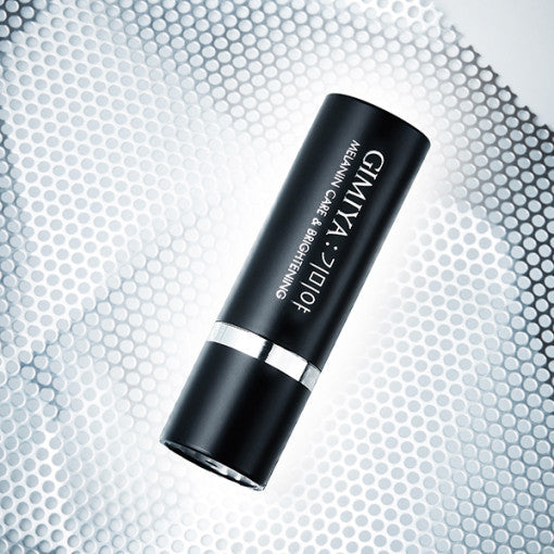 AgelessBeauty3000.com TONYMOLY | GIMIYA Melanin Care & Brightening Ampoule Stick Black cosmetic tube with silver cap on a textured gray background