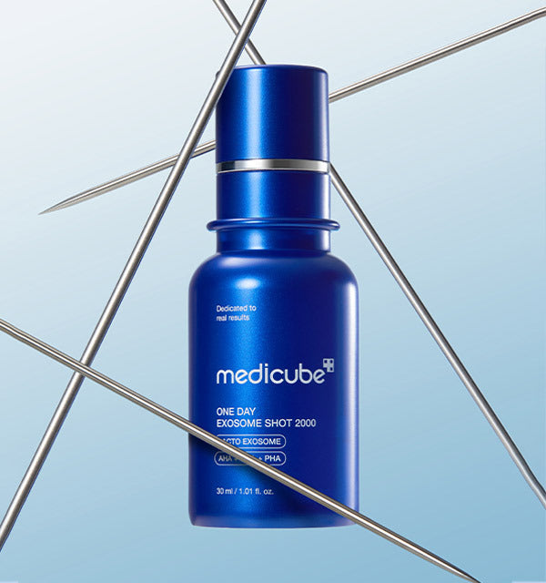 AgelessBeauty3000.com medicube |One Day Exosome Shot Pore Ampoule 2000 Blue Medicube serum bottle on a light blue background with metal rods.
