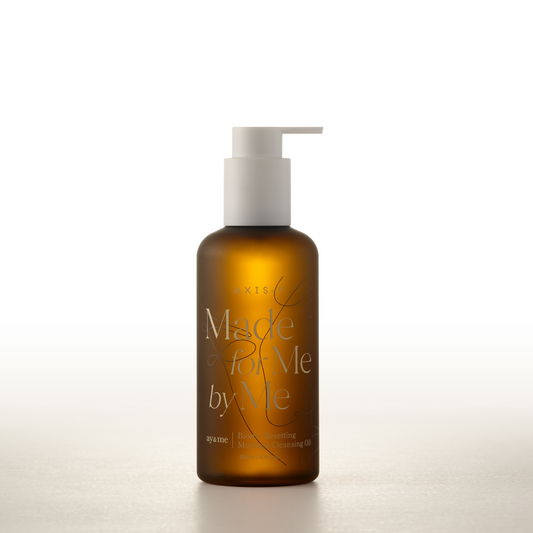 AgelessBeauty3000.com  AXIS-Y  |  Biome Resetting Moringa Cleansing Oil  Brown bottle with pump labeled 'Made by Me' on a white background