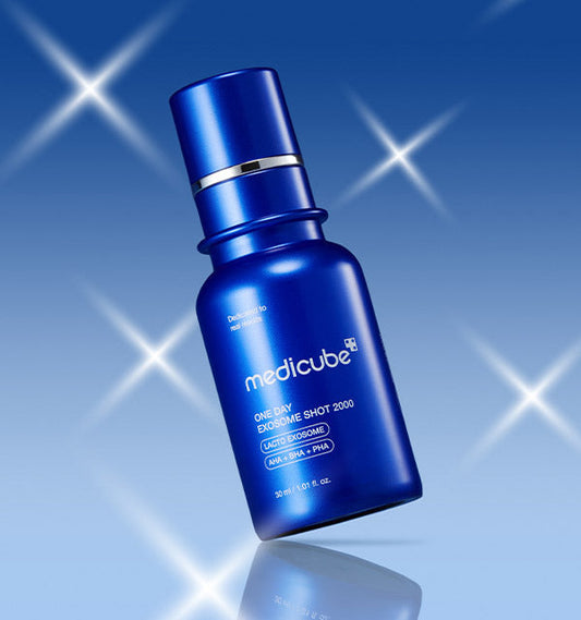 AgelessBeauty3000.com  medicube |One Day Exosome Shot Pore Ampoule 2000 Blue Medicube serum bottle on a blue background with starlight effects