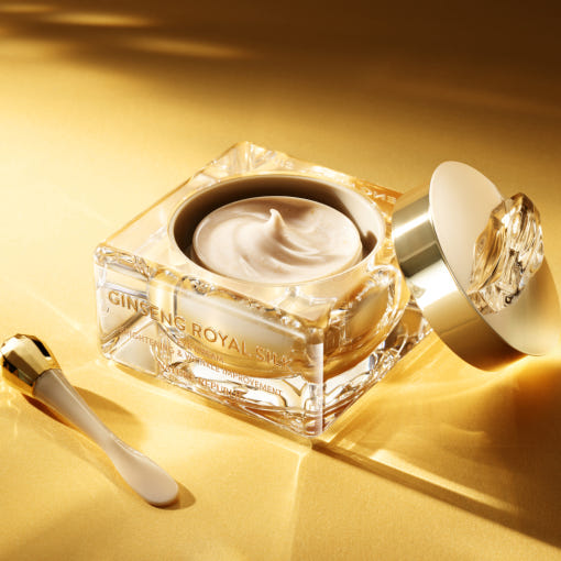 AgelessBeauty3000.com  NATURE REPUBLIC | Ginseng Royal Silk Eye Cream    Luxury skincare cream jar with applicator on a gold background