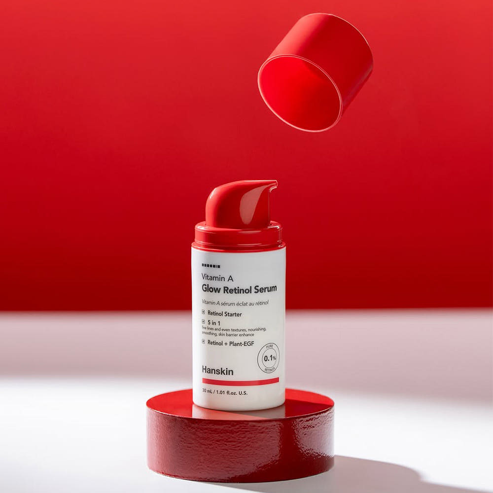 AgelessBeauty3000.com     Hanskin Vitamin A Glow Retinol Serum bottle on a red platform with a red background