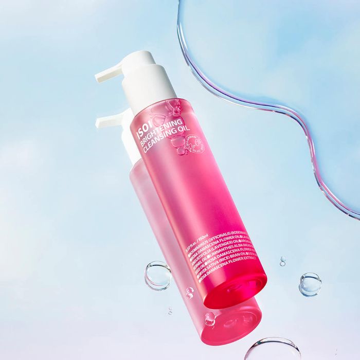 AgelessBeauty3000.com  isoi  | Brightening Cleansing OilPink bottle of cleansing oil with a white pump on a light blue background